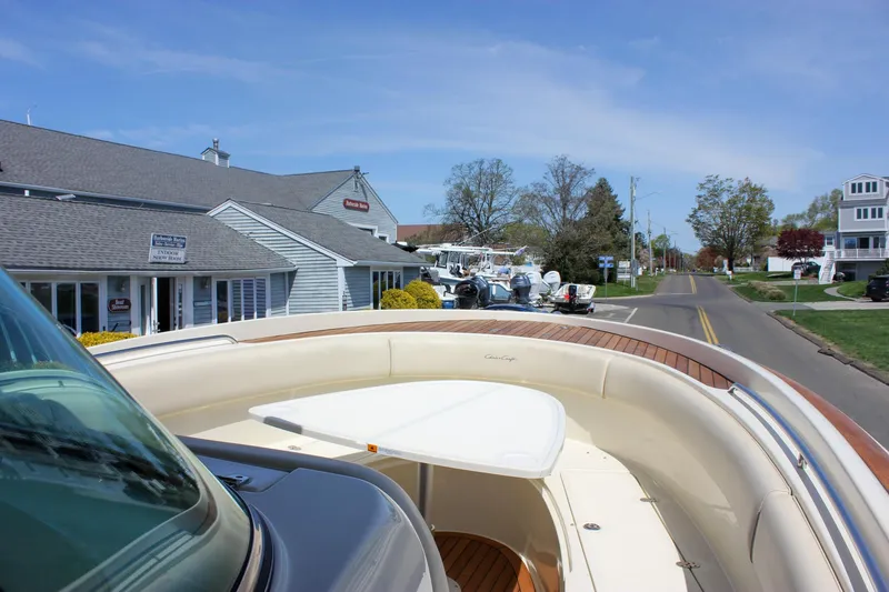 Slide: The Image of 2014 Chris-Craft Catalina 29 Sun Tender docked near a marina with buildings and road. - 40