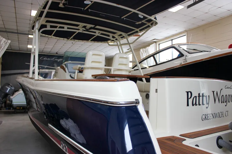 Slide: The Image of 2014 Chris-Craft Catalina 29 Sun Tender in showroom, featuring sleek design and elegant seating. - 45