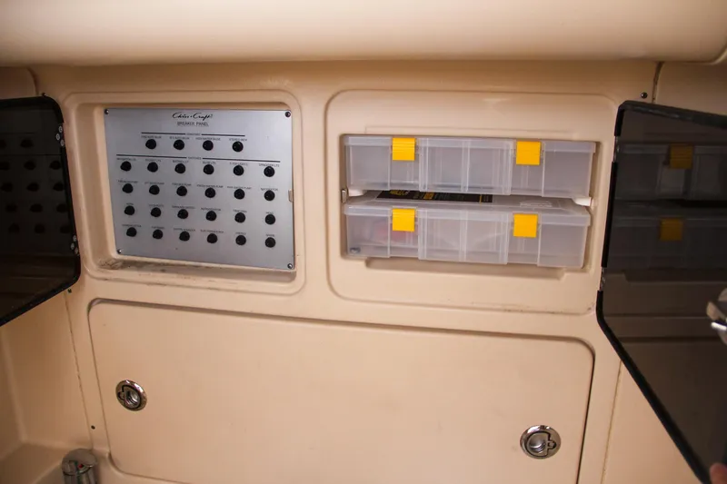 Slide: The Image of 2014 Chris-Craft Catalina 29 Sun Tender control panel and storage compartments. - 48