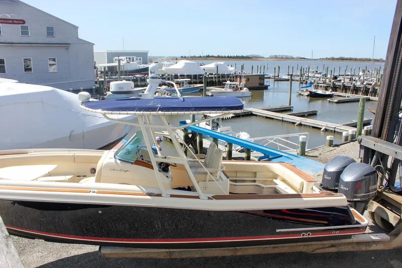 Slide: The Image of 2014 Chris-Craft Catalina 29 Sun Tender docked at a marina with clear skies. - 5