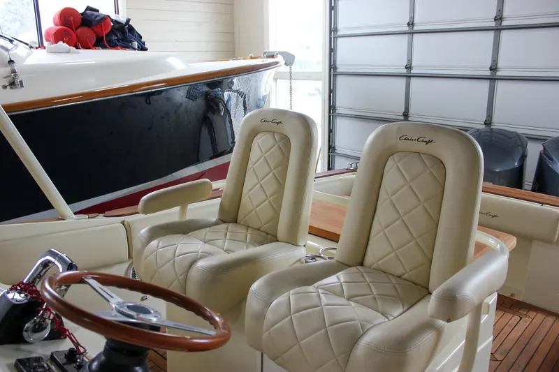 Slide: The Image of 2014 Chris-Craft Catalina 29 Sun Tender with luxurious cream leather seats and wooden steering wheel. - 7