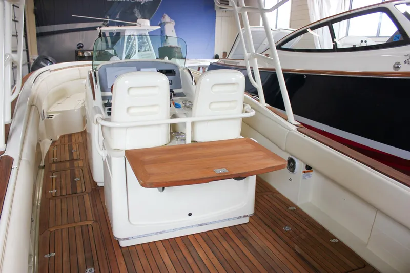 Slide: The Image of 2014 Chris-Craft Catalina 29 Sun Tender with wooden deck and seating area. - 9