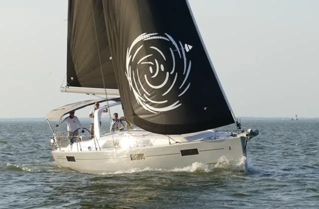 Slide: The Image of 2017 Beneteau Oceanis 41.1 sailing on open water with black sails. - 0