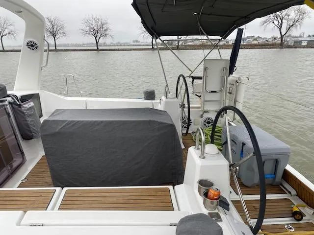 Slide: The Image of 2017 Beneteau Oceanis 41.1 sailboat cockpit with dual steering wheels and covered seating area. - 14
