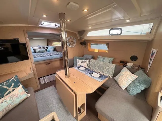 Slide: The Image of 2017 Beneteau Oceanis 41.1 interior with cozy seating, dining area, and modern decor. - 15