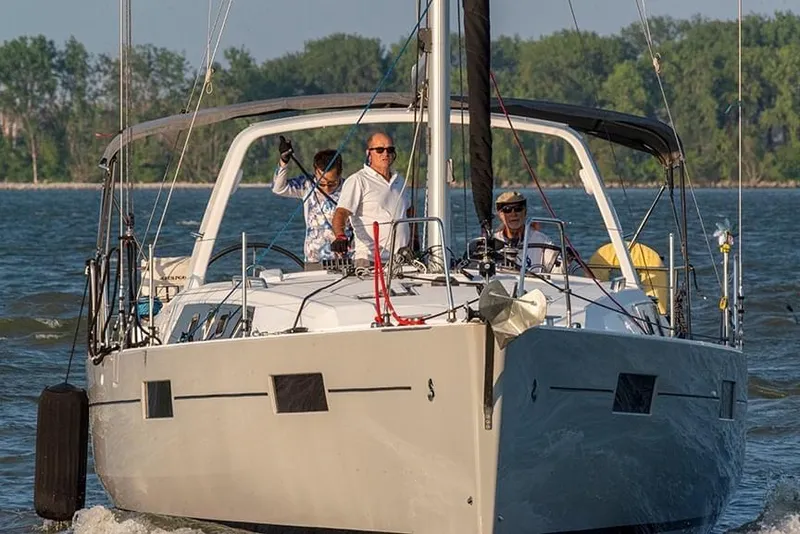 Slide: The Image of 2017 Beneteau Oceanis 41.1 sailing on a calm lake with three people onboard. - 2