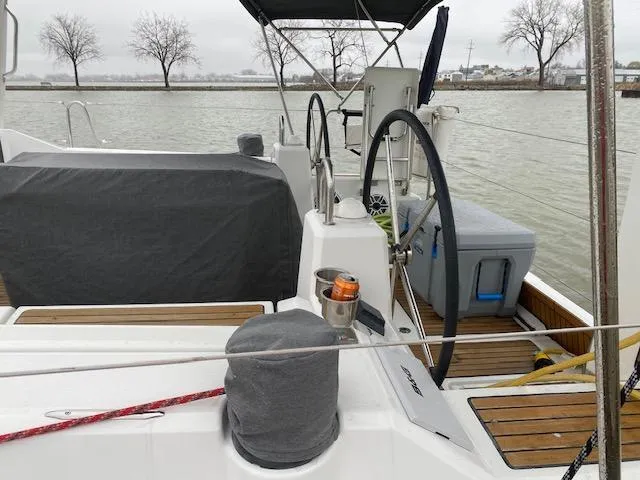 Slide: The Image of 2017 Beneteau Oceanis 41.1 sailboat cockpit with dual steering wheels and covered seating. - 9
