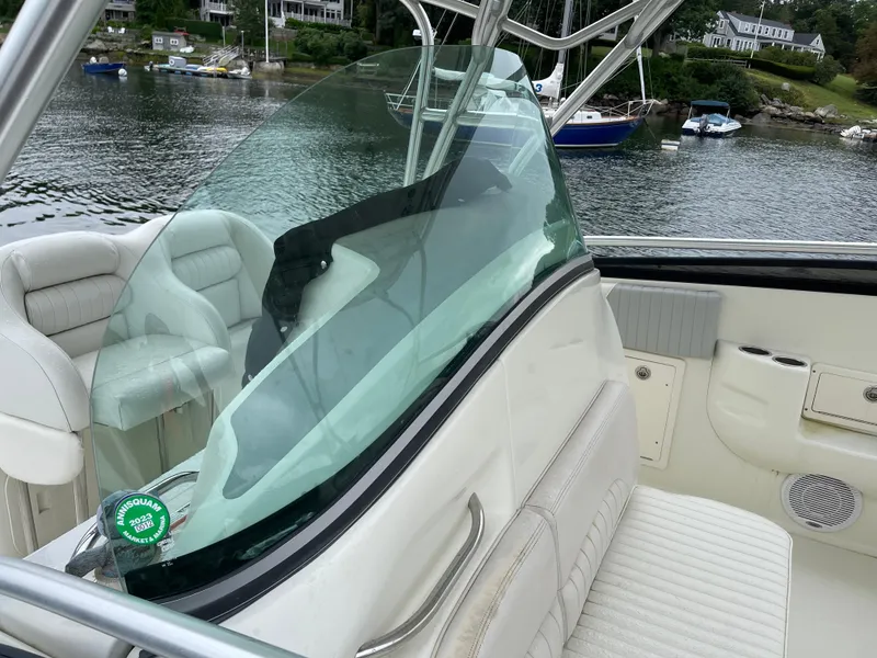 Slide: The Image of 2005 Hydra-Sports 3300 VX boat interior with white seating and clear windshield. - 11