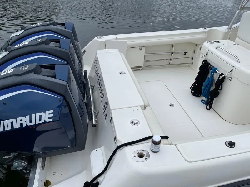 Slide: The Image of 2005 Hydra-Sports 3300 VX boat with Evinrude engines, docked on calm water. - 15