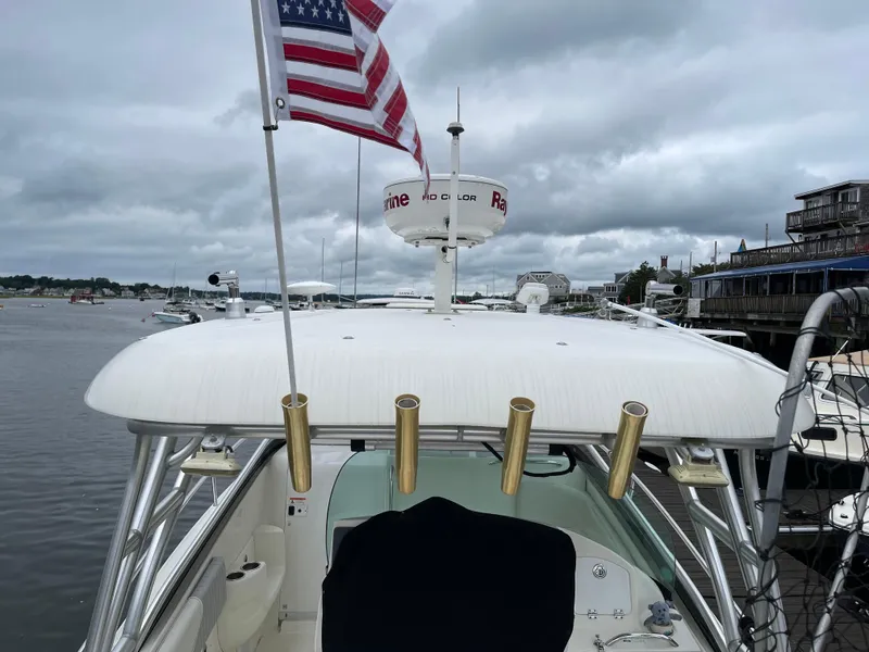 Slide: The Image of 2005 Hydra-Sports 3300 VX boat with radar, rod holders, and American flag on a cloudy day. - 17