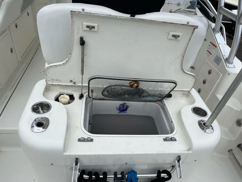 Slide: The Image of 2005 Hydra-Sports 3300 VX boat with open storage compartment and cup holders. - 18