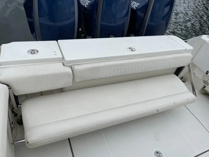 Slide: The Image of 2005 Hydra-Sports 3300 VX boat with white cushioned seating and triple outboard engines. - 21