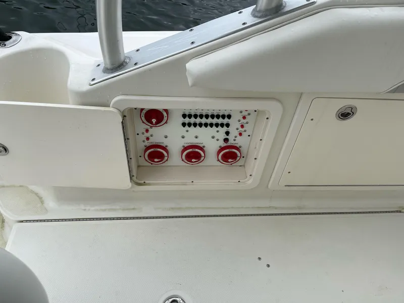 Slide: The Image of Control panel on a 2005 Hydra-Sports 3300 VX boat, featuring red dials and switches. - 22