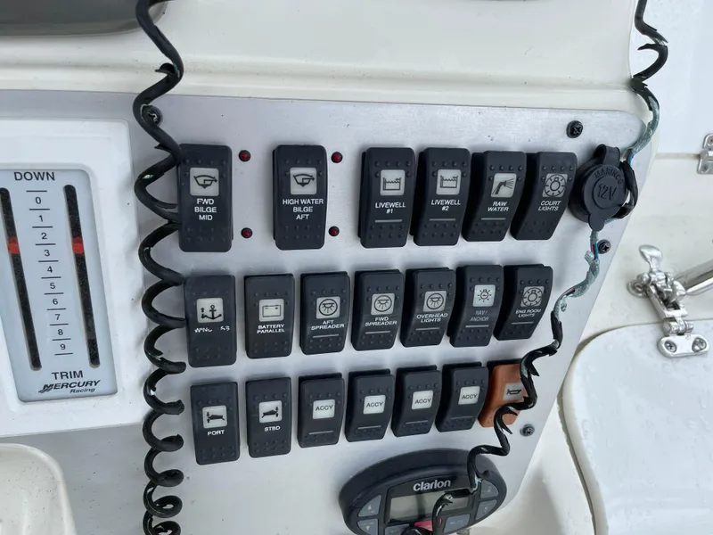 Slide: The Image of Control panel of a 2005 Hydra-Sports 3300 VX boat with various switches and trim indicator. - 23