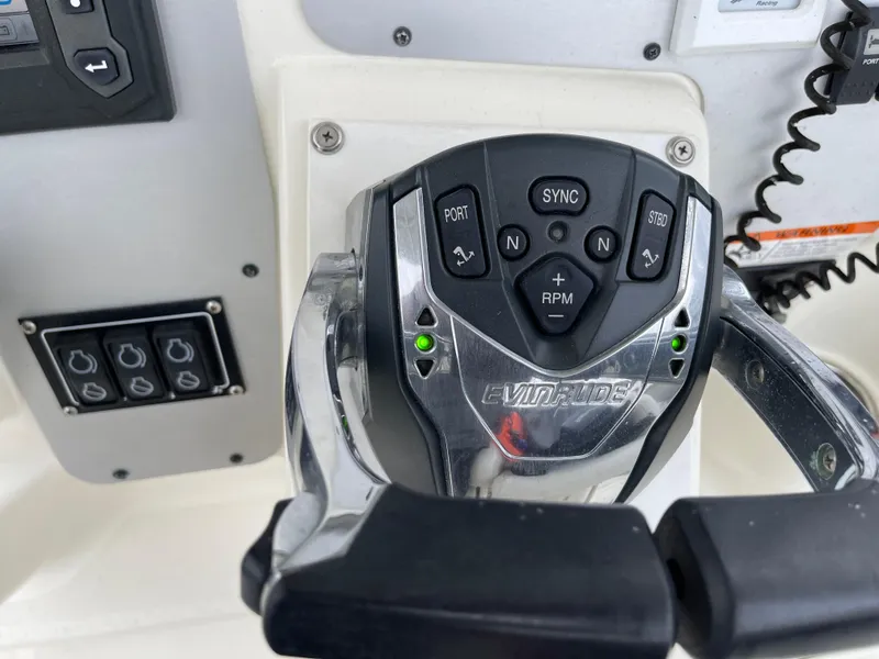 Slide: The Image of Control panel of a 2005 Hydra-Sports 3300 VX boat with Evinrude throttle. - 25
