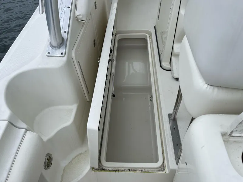Slide: The Image of 2005 Hydra-Sports 3300 VX boat interior with open storage compartment. - 26
