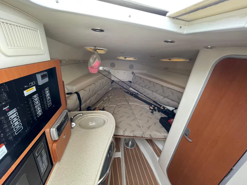 Slide: The Image of 2005 Hydra-Sports 3300 VX cabin interior with fishing rods and control panel. - 27