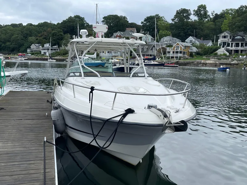 Slide: The Image of 2005 Hydra-Sports 3300 VX boat docked in a scenic marina. - 3