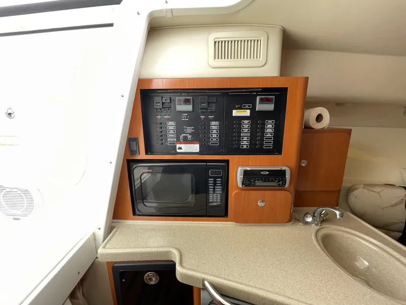 Slide: The Image of 2005 Hydra-Sports 3300 VX cabin interior with control panel, microwave, and sink. - 30