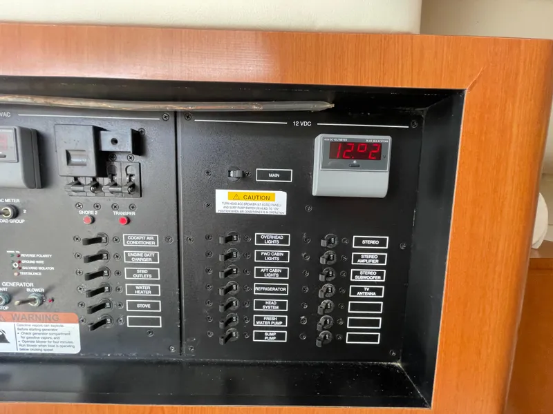 Slide: The Image of Electrical panel of a 2005 Hydra-Sports 3300 VX boat, featuring switches and digital display. - 31