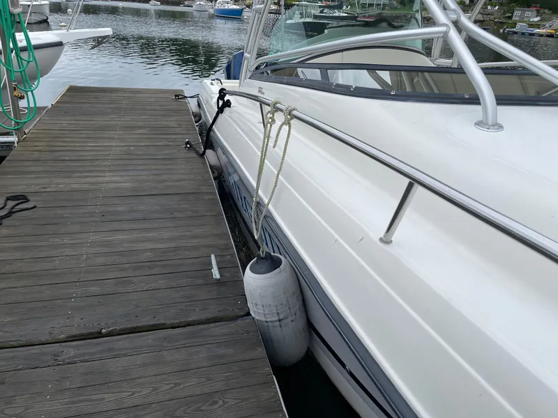 Slide: The Image of 2005 Hydra-Sports 3300 VX boat docked with fender, side view. - 8