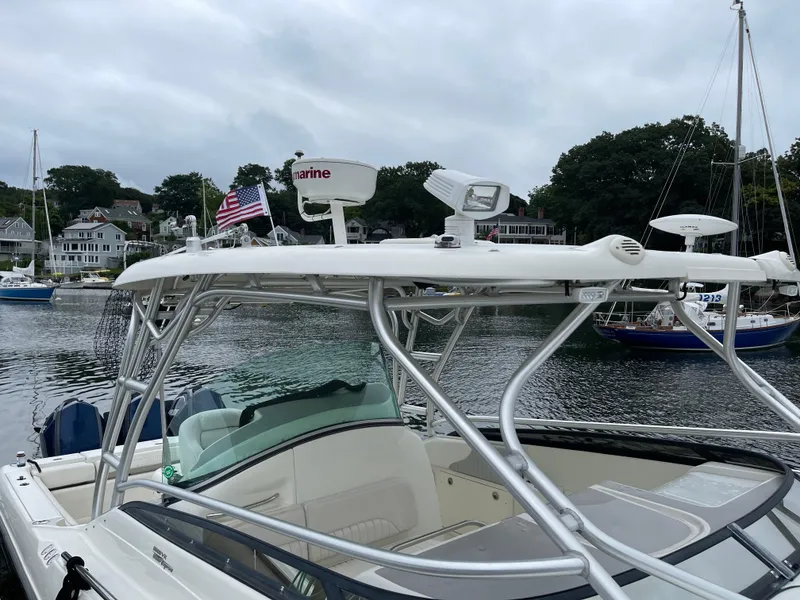 Slide: The Image of 2005 Hydra-Sports 3300 VX boat docked in a scenic marina with American flag. - 9