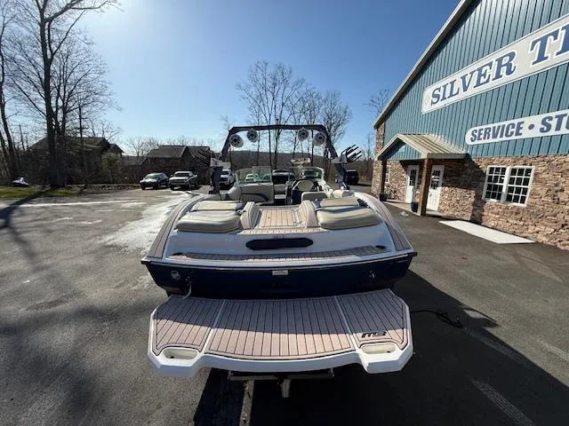 Slide: The Image of 2022 MB B-52 boat at dealership, showcasing rear deck and seating area. - 3