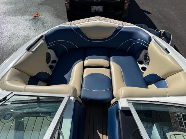 Slide: The Image of 2022 MB B-52 boat interior with blue and beige seating, featuring built-in speakers. - 5