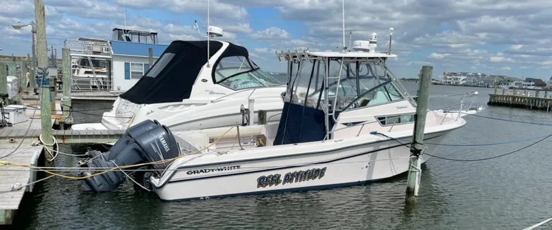 Slide: The Image of 1997 Grady-White 272 Sailfish boat docked at marina under cloudy sky. - 0