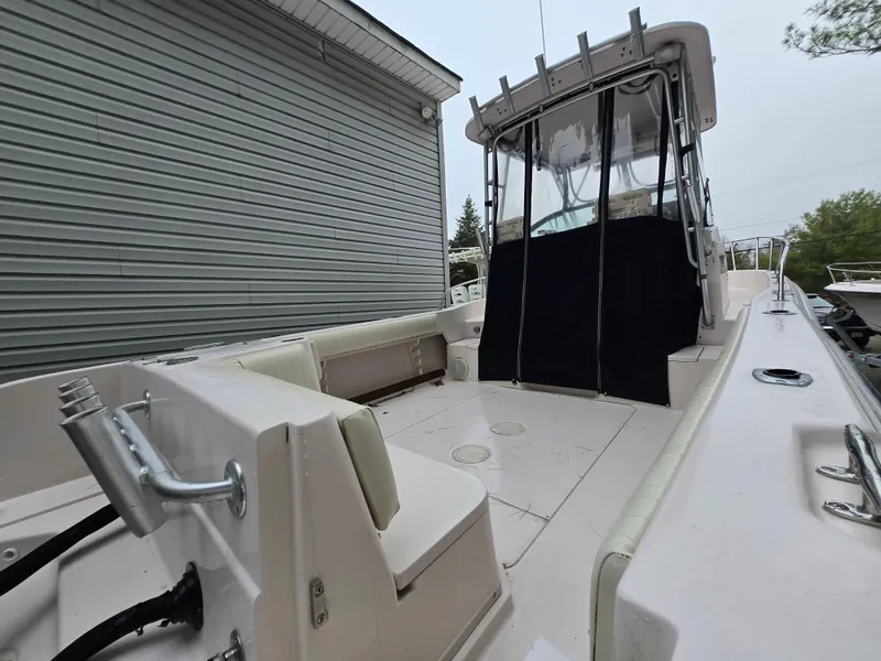 Slide: The Image of 1997 Grady-White 272 Sailfish boat with spacious deck and covered helm area. - 3