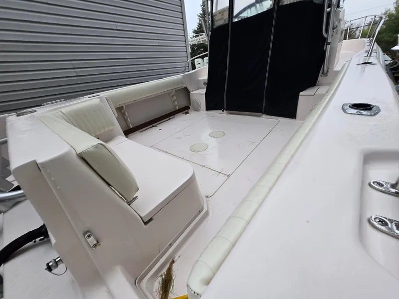 Slide: The Image of 1997 Grady-White 272 Sailfish boat interior with cushioned seating and spacious deck area. - 4