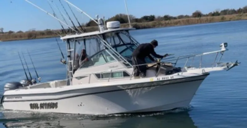 Slide: The Image of 1997 Grady-White 272 Sailfish boat on water, equipped for fishing. - 7