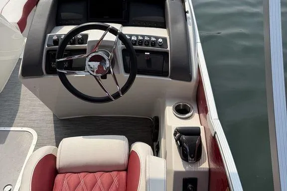 Slide: The Image of 2021 Bennington 24 RTSB boat helm with steering wheel and control panel. - 10