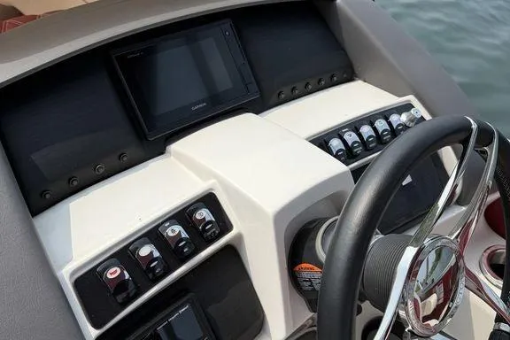 Slide: The Image of Control panel of 2021 Bennington 24 RTSB boat with steering wheel and electronic displays. - 13