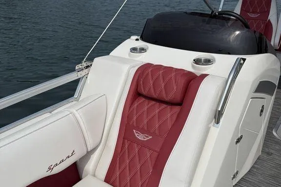 Slide: The Image of 2021 Bennington 24 RTSB boat with luxurious red and white seating on the water. - 17