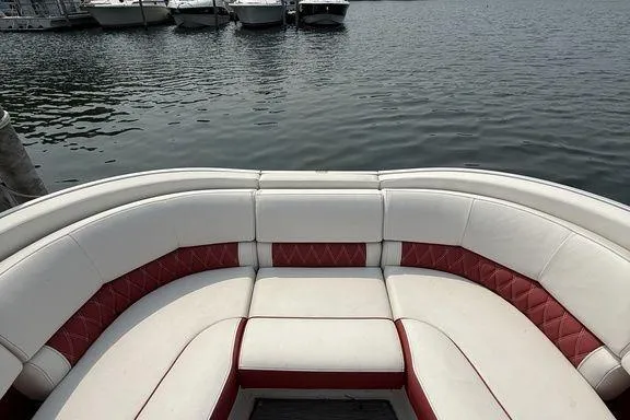 Slide: The Image of 2021 Bennington 24 RTSB boat with red and white seating, docked by the water. - 18
