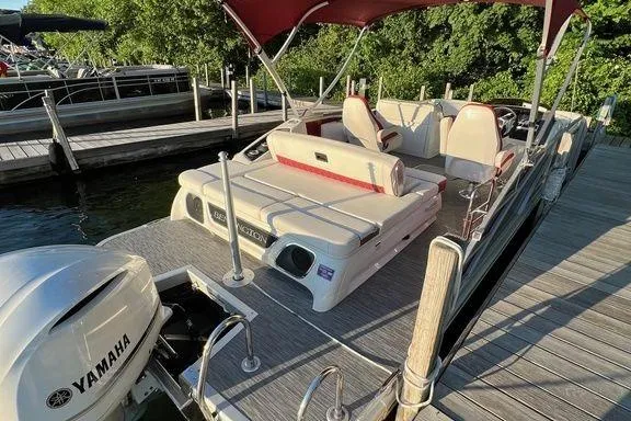 Slide: The Image of 2021 Bennington 24 RTSB pontoon boat docked, featuring Yamaha engine and spacious seating. - 21