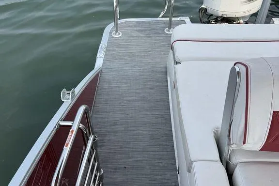 Slide: The Image of 2021 Bennington 24 RTSB boat deck with seating, featuring sleek design and water backdrop. - 5