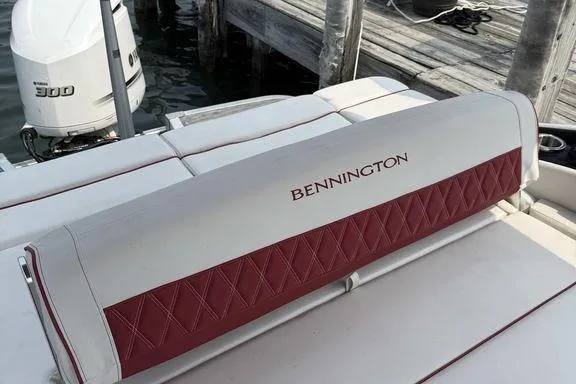 Slide: The Image of 2021 Bennington 24 RTSB boat seat with red and white upholstery near dock. - 8