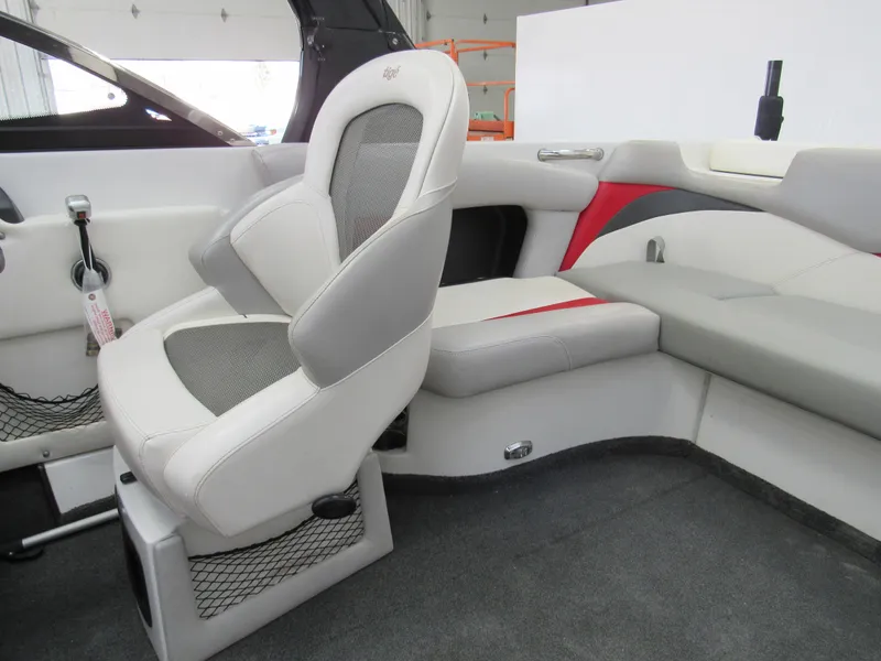 Slide: The Image of 2009 Tigé 22 EV boat interior with white and gray seating, red accents, and carpeted flooring. - 6