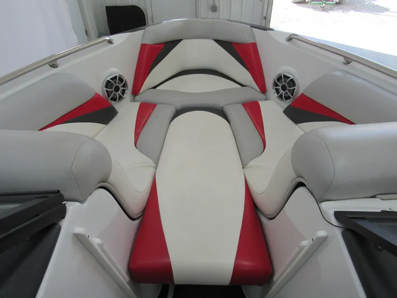 Slide: The Image of 2009 Tigé 22 EV boat interior with red, black, and white seating. - 8
