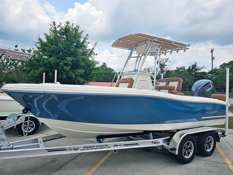 Slide: The Image of 2025 Pioneer 202 Sportfish boat on trailer, blue hull, outdoor setting. - 1