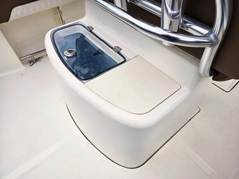 Slide: The Image of 2025 Pioneer 202 Sportfish boat console with storage compartment and stainless steel railing. - 10