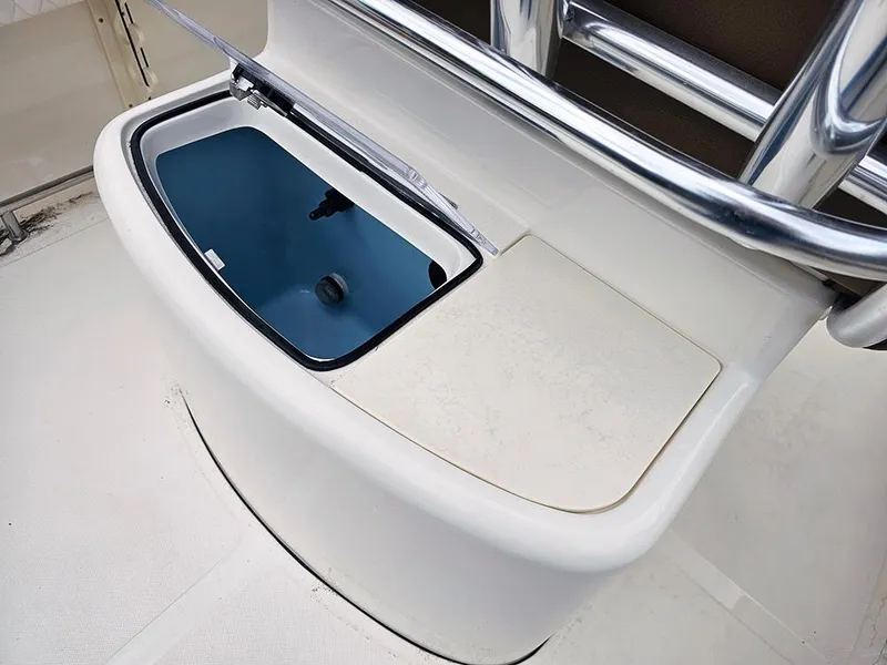 Slide: The Image of 2025 Pioneer 202 Sportfish boat livewell with open lid, showcasing interior design. - 11