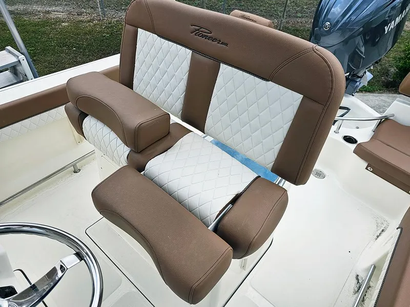 Slide: The Image of 2025 Pioneer 202 Sportfish boat seat with brown and white quilted upholstery. - 13