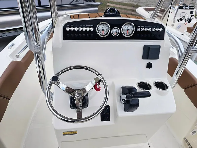 Slide: The Image of 2025 Pioneer 202 Sportfish boat dashboard with steering wheel and control panel. - 14