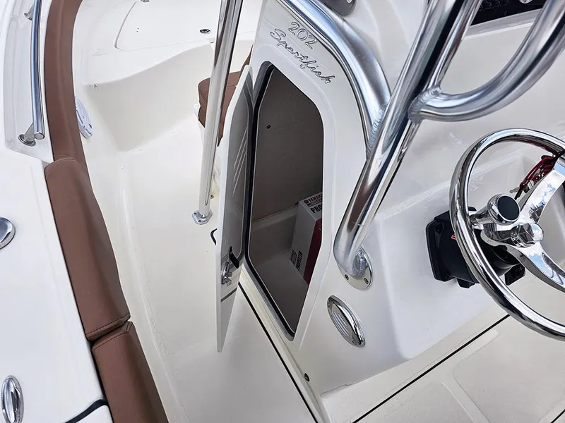Slide: The Image of 2025 Pioneer 202 Sportfish boat interior with open console door and steering wheel. - 16