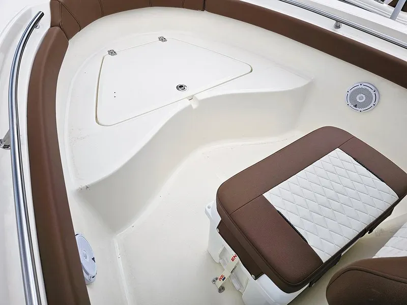 Slide: The Image of 2025 Pioneer 202 Sportfish boat interior with cushioned seating and storage compartment. - 17