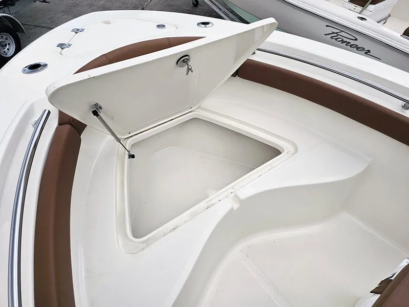 Slide: The Image of 2025 Pioneer 202 Sportfish boat with open storage compartment on deck. - 18