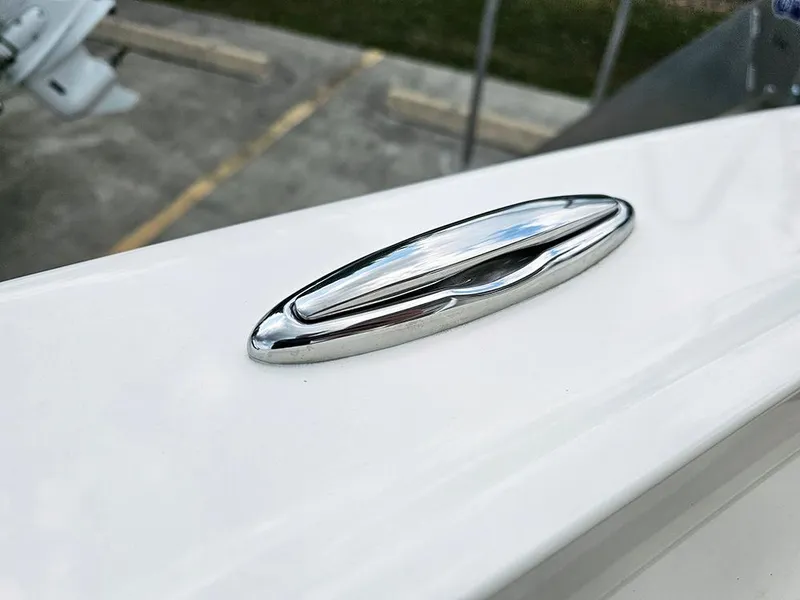 Slide: The Image of 2025 Pioneer 202 Sportfish boat detail, featuring sleek chrome hardware on a white surface. - 21